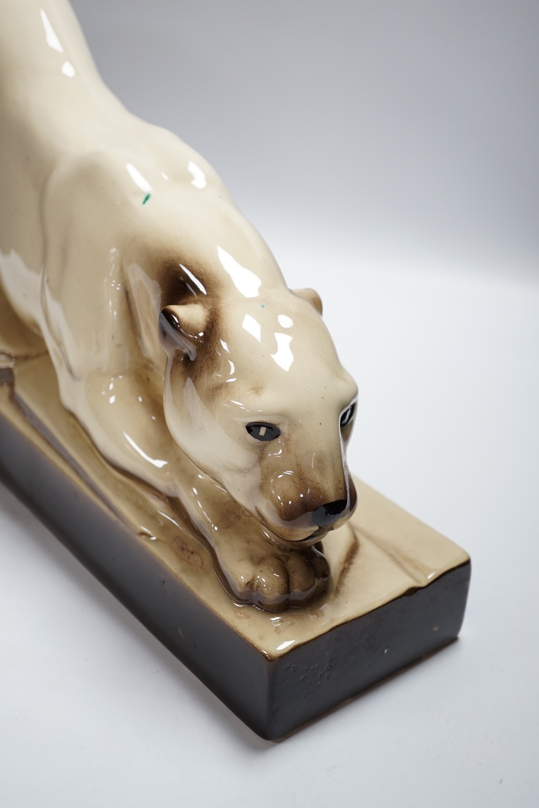 An Art Deco porcelain model of a panther, indistinctly signed, 57cm